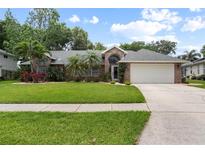Charming single-Gathering home with well-maintained lawn, landscaped garden, and a two-car garage at 5776 White Acres Ln, Port Orange, FL 32127