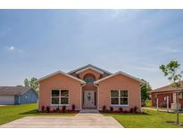 Charming single-story home with well-manicured lawn and concrete driveway at 707 Hamilton St, New Smyrna Beach, FL 32168