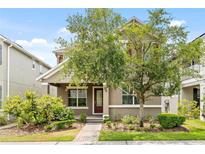 Charming two-story home featuring a landscaped front yard and a welcoming entrance at 8832 Ribault Ave, Orlando, FL 32832