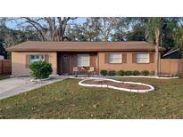 Inviting single-story home featuring well-maintained landscaping and a cozy front porch area at 921 Valleydale Ave, Deland, FL 32720
