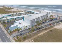Aerial view of the beachfront property with multiple buildings, parking, and easy beach access at 935 S Atlantic Ave # 363, Daytona Beach, FL 32118