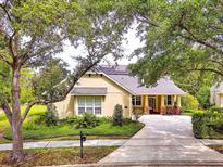 Charming home featuring a well-manicured lawn, inviting front porch, and a convenient circular driveway at 1018 Heron Point Cir, Deland, FL 32724