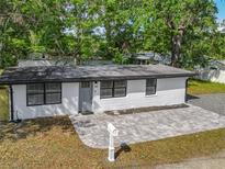 Charming single-story home featuring a fresh white exterior, new gray brick walkway, and mailbox at 102 Judges Ln, Port Orange, FL 32129