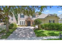 Charming two-story home featuring a stone entryway and a well-manicured front lawn at 123 Ivydale Manor Dr, Deland, FL 32724