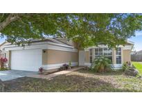 Charming home featuring a well-maintained lawn and a two-car garage at 14634 Brightwell Ct, Orlando, FL 32824