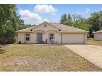 Charming single-story home featuring a well-maintained lawn and attached two-car garage at 149 Angeles Rd, Debary, FL 32713