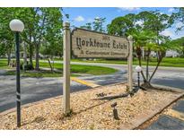 Yorktowne Estates condominium sign featuring the community name and lush green landscaping at 1601 Big Tree Rd # 1302, South Daytona, FL 32119