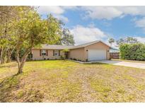 Charming single-story home featuring a well-manicured lawn and two-car garage in a quiet neighborhood at 1617 Tuscaloosa Ave, Daytona Beach, FL 32117
