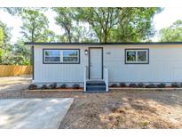 Charming home with manicured flowerbeds flanking the entry at 165 S Massachusetts Ave, Deland, FL 32724