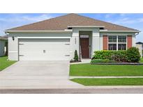 Charming single-story home with a well-manicured lawn, two car garage, and welcoming curb appeal at 2000 White Pelican Ter, Sanford, FL 32771
