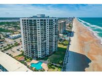 Stunning aerial view of a beachfront condo building with a pool and expansive beach access at 2425 S Atlantic Ave # 1202A, Daytona Beach Shores, FL 32118