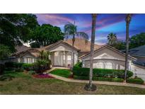 Charming single-story home with lush landscaping, tiled roof, and inviting entryway at 340 Hampton Hills Ct, Debary, FL 32713