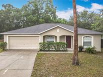 Charming single-story home featuring a two-car garage, manicured landscaping, and a welcoming front entrance at 400 Landress Ln, Deland, FL 32724
