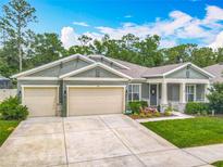 Charming single-story home with a manicured lawn, featuring a two-car garage and inviting front porch at 409 Nowell Loop, Deland, FL 32724