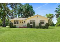 Charming single-story home with a well-maintained lawn and neatly trimmed shrubbery at 51 Silk Moss Ct, South Daytona, FL 32119