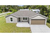 Charming one-story home featuring a two-car garage, well-manicured lawn, and a welcoming front entrance at 560 Sumner Ave, Orange City, FL 32763