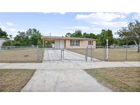 Charming single-story home with a fenced yard and covered carport at 566 S Floyd Cir, Deltona, FL 32725