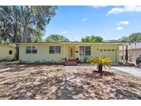 Charming single-story home with a well-maintained lawn, classic architecture, and mature landscaping at 632 Tarragona Way, Daytona Beach, FL 32114