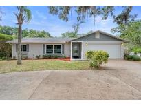Charming single-story home with an attached garage and well-maintained landscaping in a desirable neighborhood at 990 W French Ave, Orange City, FL 32763