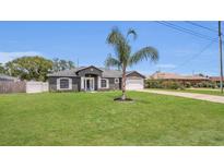 Well-maintained single-story home with landscaped front yard and attached two-car garage at 1194 Balfour Dr, Deltona, FL 32725