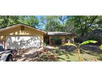 Charming single-story home with a two-car garage, landscaped yard and a mix of brick and siding exterior at 1621 Anniston Ave, Daytona Beach, FL 32117