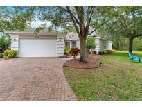 Well-maintained single Gathering home featuring lush landscaping and a brick driveway at 191 Sedona Cir, Daytona Beach, FL 32124