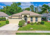 Charming single-story home with a well-manicured lawn, mature landscaping, and a two-car garage at 200 Gala Cir, Daytona Beach, FL 32124