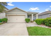 Charming single-story home featuring a two-car garage, well-manicured lawn, and welcoming curb appeal at 211 Duke Dr, Deland, FL 32724