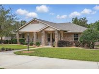 Charming brick home with manicured lawn, inviting entrance, and well-maintained landscaping at 226 Treeline Ln, Ormond Beach, FL 32174