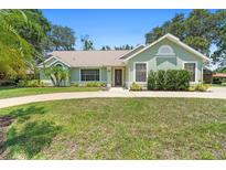 Charming single-story home with a well-maintained lawn, mature trees, and a welcoming entrance at 25 Pine Glen Dr, Debary, FL 32713