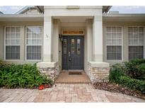 Inviting front entrance featuring a stylish door, sidelights and a brick walkway at 319 Bellingrath Ter, Deland, FL 32724