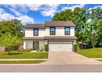 Charming two-story home with a well-manicured lawn, two-car garage and inviting curb appeal at 348 Southern Winds Blvd, Deland, FL 32720