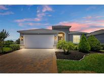 Charming single-Gathering home features a two-car garage, landscaped yard, and a brick driveway at 518 Briarbrook Way, Deland, FL 32724