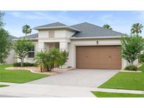 Beautiful single-story home featuring a well-manicured lawn and two-car garage at 5513 Estero Loop, Port Orange, FL 32128