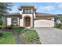 Charming home showcasing a well-manicured lawn and a two-car garage at 6254 Woodhaven Village Dr, Port Orange, FL 32128