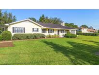 Charming single-story home with lush green lawn and mature landscaping at 701 N Tuxedo Ave, Deland, FL 32724