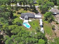 Aerial shot highlighting a pool, RV parking, spacious backyard, and peaceful surroundings at 851 W Wisconsin Ave, Orange City, FL 32763