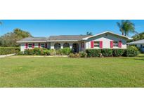 Charming single-story home with well-maintained lawn, red shutters, and mature landscaping at 1155 E Fowler Dr, Deltona, FL 32725