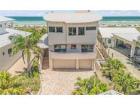 Unique, three-story home with a curved roof, a three car garage, and beachfront access and views at 1209 N Atlantic Ave, New Smyrna Beach, FL 32169