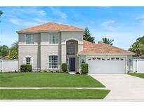 Charming two-story home with manicured lawn, neutral exterior, and well-maintained landscaping at 1491 Nappa Dr, Port Orange, FL 32128