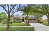 Charming single-story home with a well-maintained lawn, mature trees, and an attached two-car garage at 1637 Bent Oaks Blvd, Deland, FL 32724