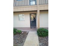 Inviting condo front door with a welcome mat, set in a garden-style community at 1640 Juno Trl # 103F, Astor, FL 32102