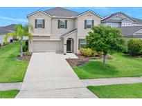 Charming two-story home with lush landscaping, a well-manicured lawn, and a spacious driveway at 1923 Mendocino Ln, Port Orange, FL 32128