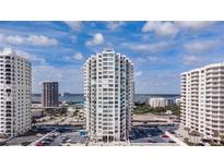Exterior view of the high-rise condo building on a sunny day, with views of the coastline and surrounding buildings at 2987 S Atlantic # 606, Daytona Beach Shores, FL 32118