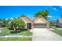 Charming single-story home featuring a well-manicured lawn and attractive landscaping at 706 Fox Tail Ct, New Smyrna Beach, FL 32168