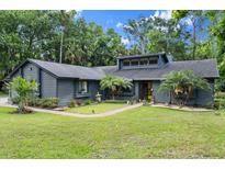 Charming single-story home featuring a well-manicured lawn and beautifully landscaped front yard at 96 Hollow Branch Xing, Ormond Beach, FL 32174