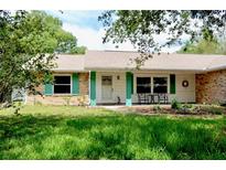 Charming single-story home with a well-maintained lawn and colorful shutters at 1010 Hanford Dr, Deltona, FL 32738