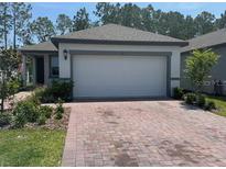 Charming one-story home features a paved driveway, neutral colors and a two-car garage at 112 Lost Ball Dr, Daytona Beach, FL 32124