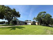 Charming single-story home with well-maintained lawn, mature trees, and a two-car garage at 1301 Killian St, Daytona Beach, FL 32114