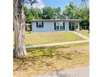 Charming single-story home featuring a well-maintained front yard and a sidewalk leading to the entrance at 1485 Gainsville Dr, Deltona, FL 32725